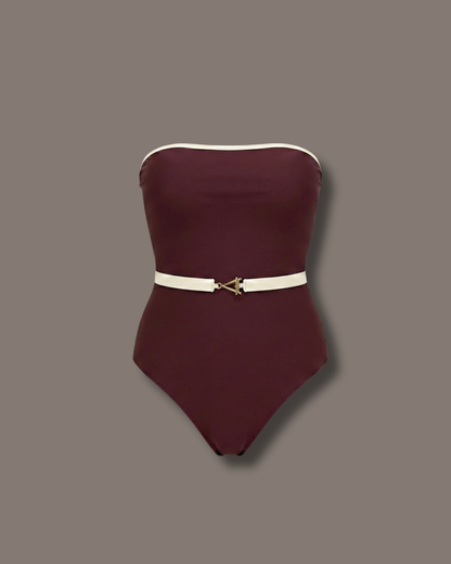 Amira One-Piece, maroon swimsuit with white accents shoot in a studio background, front scene.