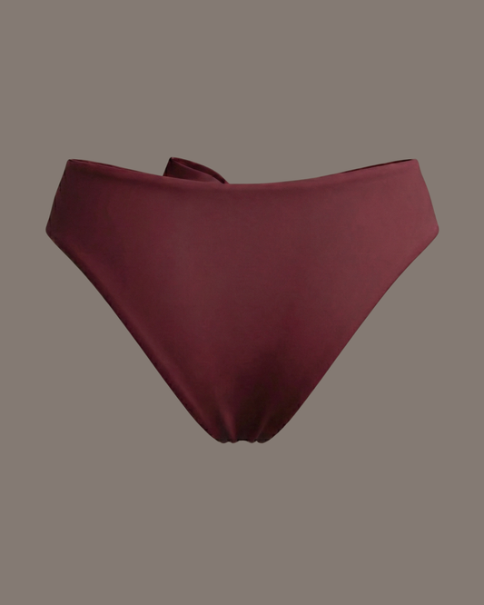 Maroon bikini bottom on a studio background